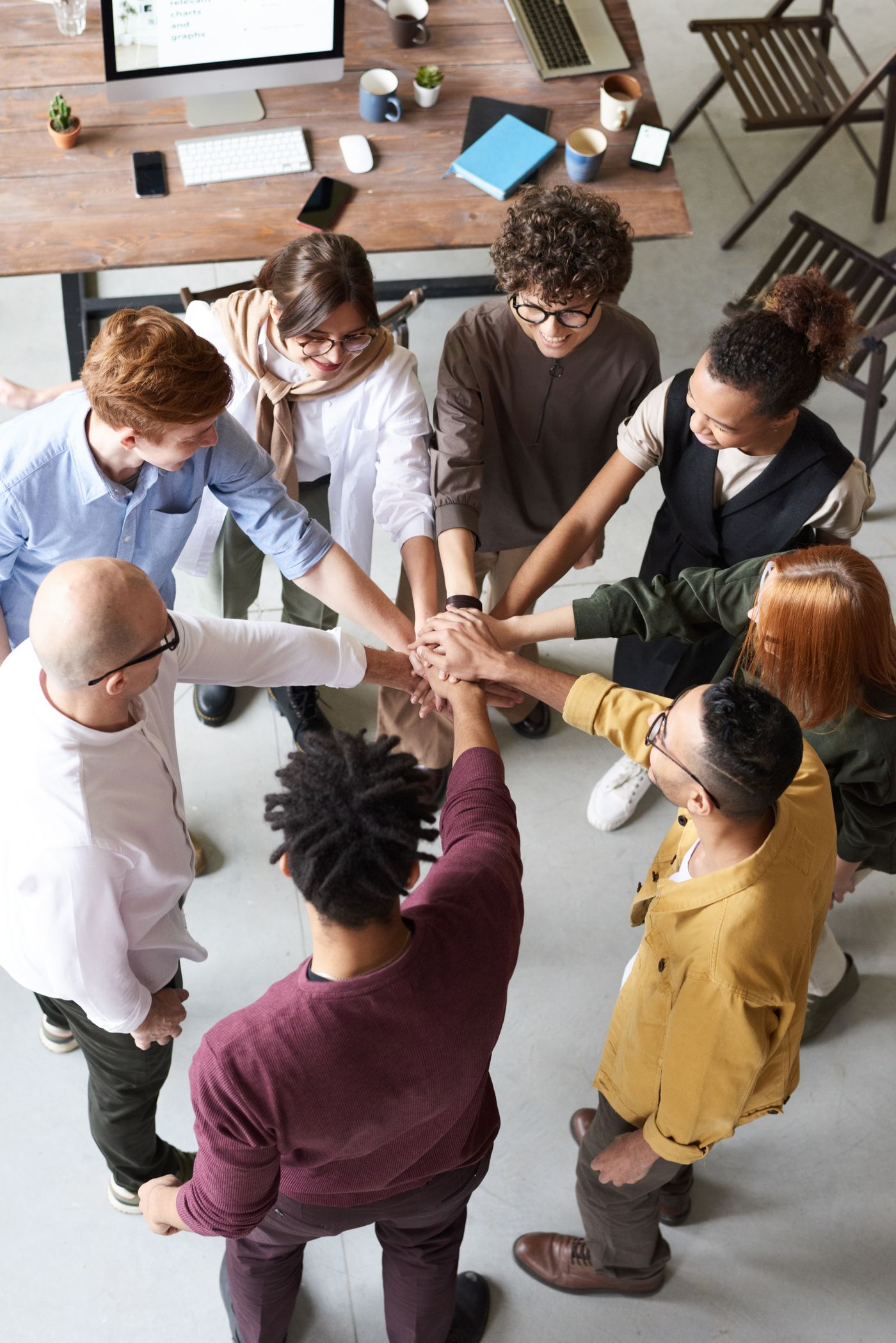 A diverse group joining hands together in a circle