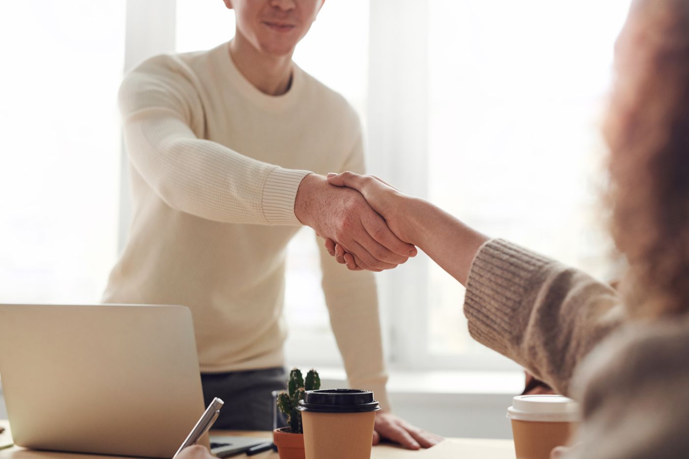 Two people shaking hands in partnership